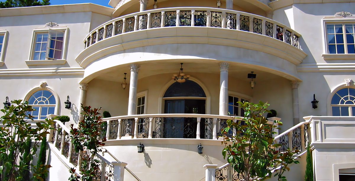 A curved double-balcony residence in cream coated stone.