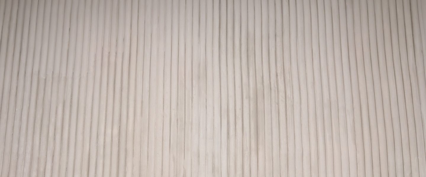 A fluted cream surface.